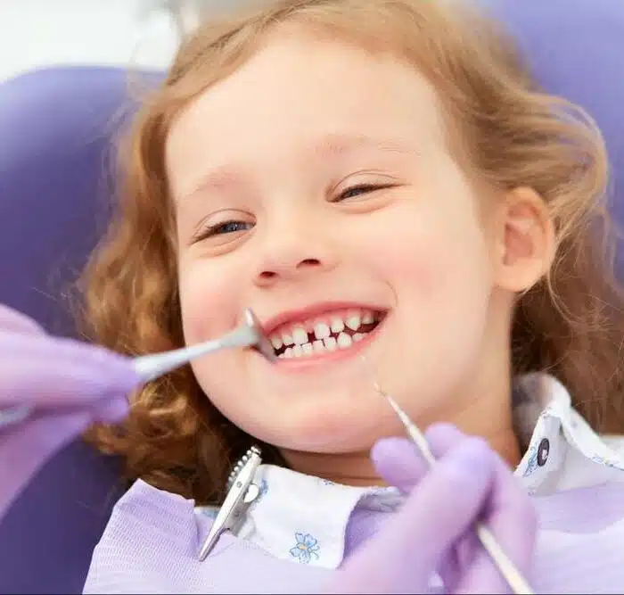 Orthodontist performing checkup on child